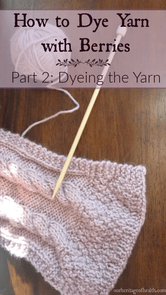 Ball of pale lavender yarn with knitting needle and end of knitted scarf.