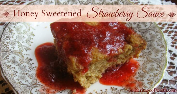 Honey sweetened strawberry sauce drizzled over a piece of cornbread on a plate.
