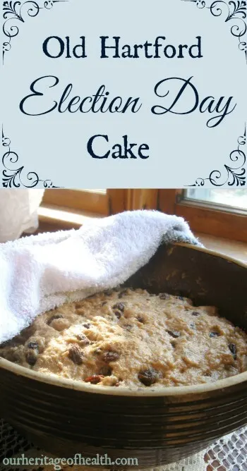 Bowl of Election Day cake batter with raisins and currants with a towel partly draped over the bowl.
