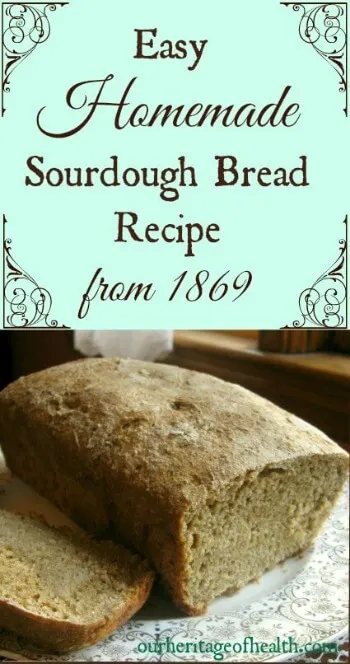 Loaf of sourdough bread on a plate with a slice cut out of it.