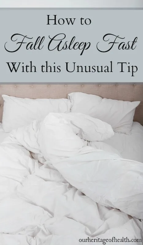 White pillows and crumpled sheets on a bed.