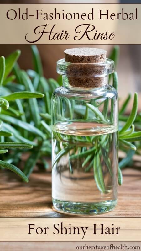 Old-fashioned cork-topped bottle with sprigs of rosemary in the background.