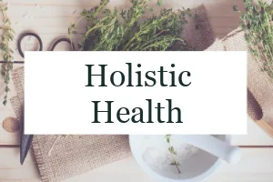 Herbs and a mortar and pestle with the text overlay "Holistic Health."