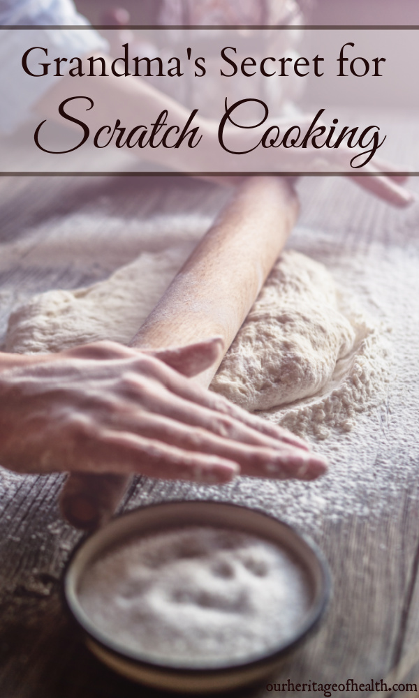 Hands using a rolling pin to roll out dough on a floured counter.