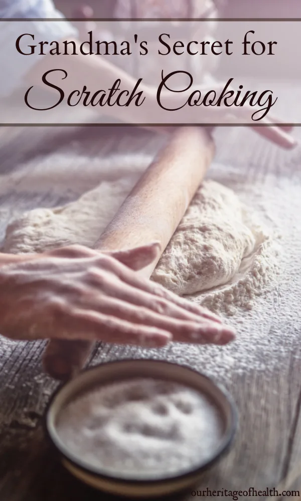 Hands using a rolling pin to roll out dough on a floured counter.