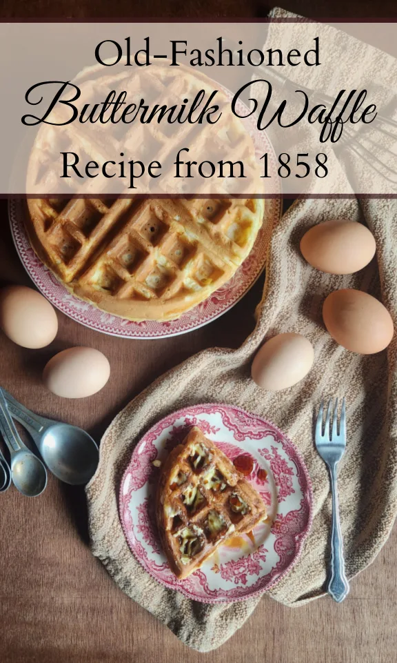 A piece of waffle with butter and maple syrup on a red china plate with a brown striped cloth underneath and a plate piled high with waffles in the background along with eggs, a whisk, and measuring spoons and a text overlay that says, "Old-Fashioned Buttermilk Waffle Recipe from 1858."