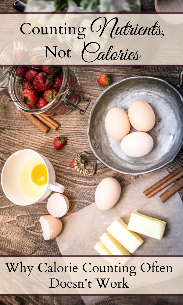Table with ingredients scattered on it including butter, eggs, cinnamon sticks, and strawberries and a decorative bird figurine and flowers beside them and text overlays that said "Counting Nutrients, Not Calories" and "Why Calorie Counting Often Doesn't Work."