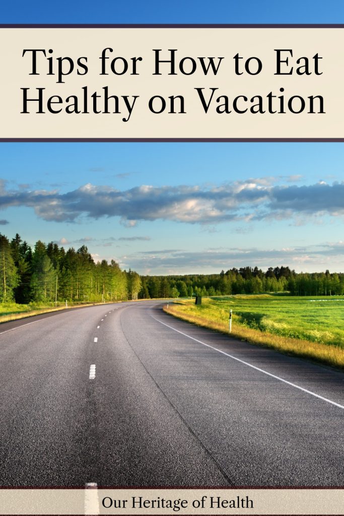 Asphalt road with trees on one side and an open field on the other and blue sky above with a text overlay that says "Tips for How to Eat Healthy on Vacation."